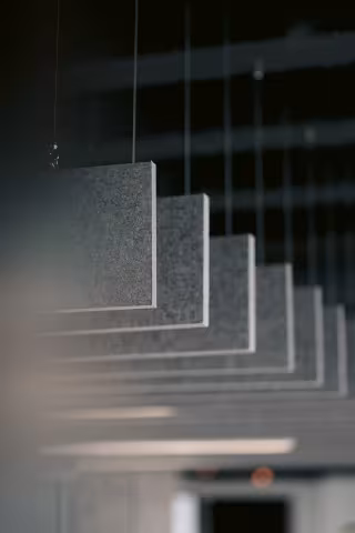Modern architectural ceiling detail with suspended linear lighting in Grenadier Holdings’ office interior