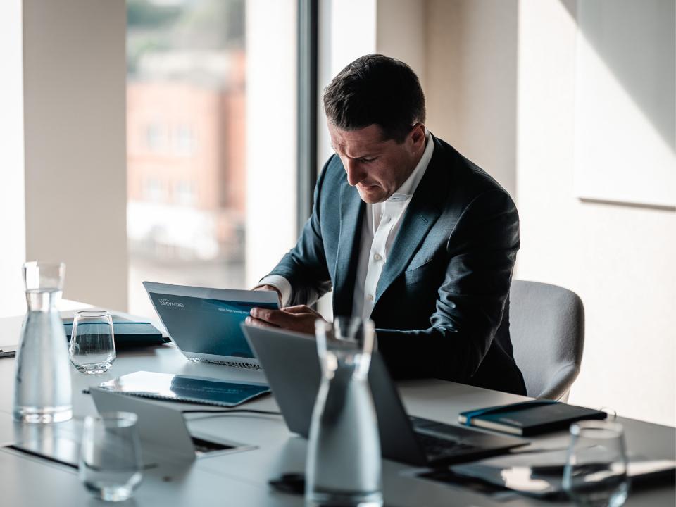 Grenadier Holdings employee reviewing documents in a meeting room