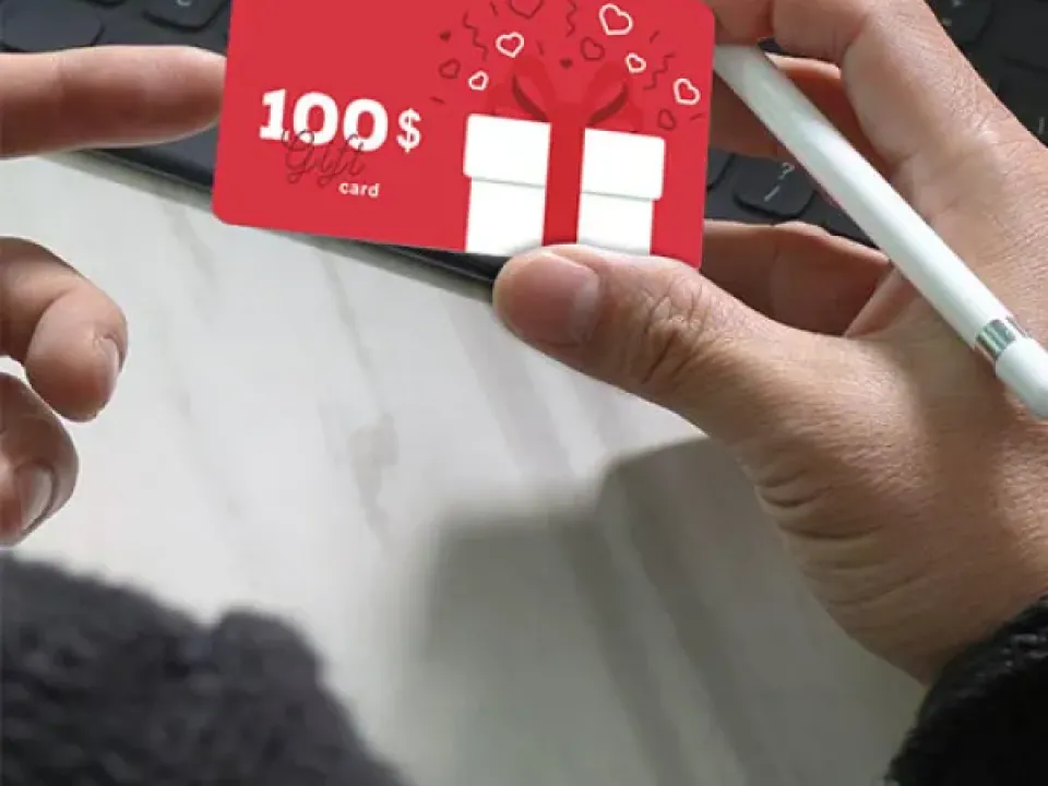 Person holding a red gift card